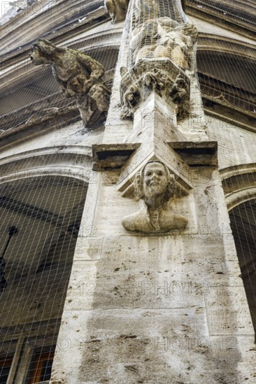 Pillar with sculptures, neo-Gothic architectural detail in the inner courtyard of the town hall in Munich, Bavaria, Germany