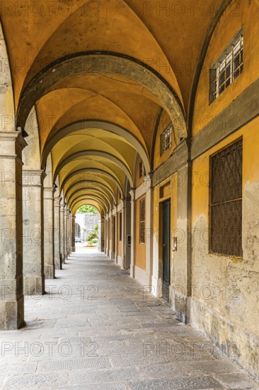 Arched arcades in Via Elisa, historic city centre, Lucca, Tuscany, Italy