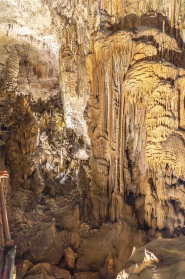 Tourists marvel at the stunning stalactites and stalagmites formations inside postojna cave, a popular destination in slovenia