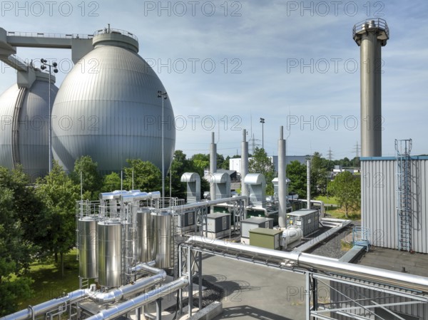 Dinslaken, North Rhine-Westphalia, Germany - Combined heat and power plants (CHP) generate electricity from wastewater digester gases, which is used by the Emscher-Mündung sewage treatment plant for its own power supply. The old CHP unit at the Emscher-Mündung sewage treatment plant in Dinslaken is getting on in years and needs to be replaced. Temporary rental CHP units (pictured here) relieve the stationary CHP units so that they can then be renewed or replaced