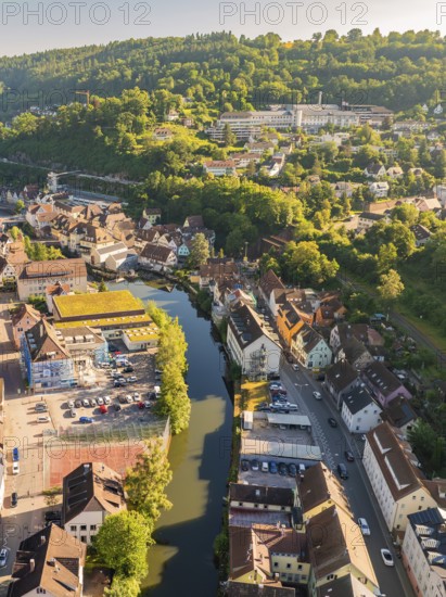 Aerial view of a town along a river with car parks, surrounded by hills and forests, Calw, Black Forest, Germany