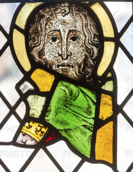 Stained glass window depiction of medieval man face, Bristol cathedral church, Bristol, England, UK