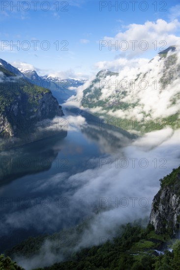 Atmospheric clouds over the fjord in the morning light, view of Geirangerfjord, at Ørnesvingen viewpoint, near Geiranger, Møre og Romsdal, Norway