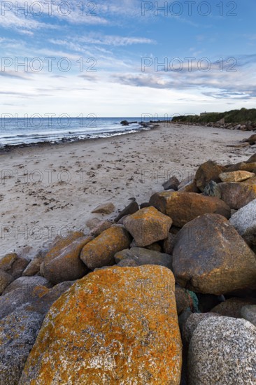 Coastal defence, boulders with view on sandy beach, dusk, Carne Beach, Wexford, Gerrans Bay, Roseland Peninsula, Ireland