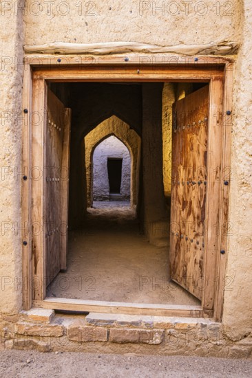 View through an entrance door in the largest preserved mud town in Oman, Al Bilaad, Al Bilaad Historical Village, Arabian Peninsula, Sultanate of Oman