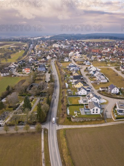Aerial view of a rural suburb with streets and houses next to open fields, Schopfloch, Freudenstadt district, Germany