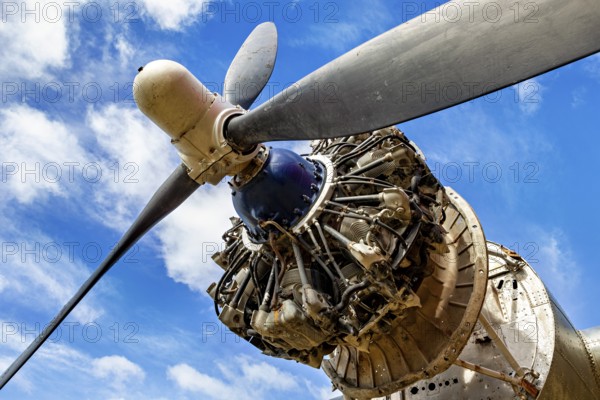 Aeroplane propeller from close up in front of a blue sky with clouds, The propeller of an aeroplane at Ushuaia airport in Argentina