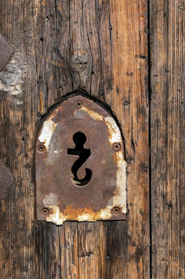 Keyhole in the form of an upside-down question mark in the portal of the Chiesa SS. Giacomo e Filippo, a Romanesque church on the ground of the castle ruins of Castello di Andora, province of Savona, Liguria, Italy