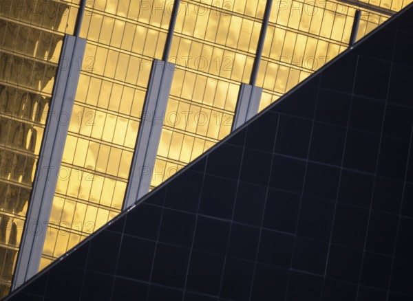 A visually striking composition of modern architecture in Las Vegas. The image features contrasting textures and colors, with reflective gold and sleek dark surfaces
