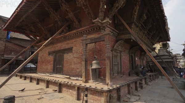 Traditional Nepalese building, temple with detailed wooden architecture and support beams after the earthquake at Durbar Square in Kathmandu, Nepal