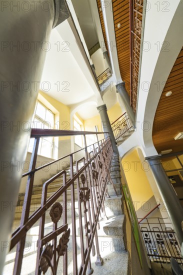 Historic staircase with arches and columns. Light falls through the windows, the structure looks impressive, Jugend Musiziert, Nagold, Germany