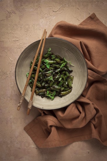Fried bean pods, in soy sauce, with sesame seeds, homemade, no people