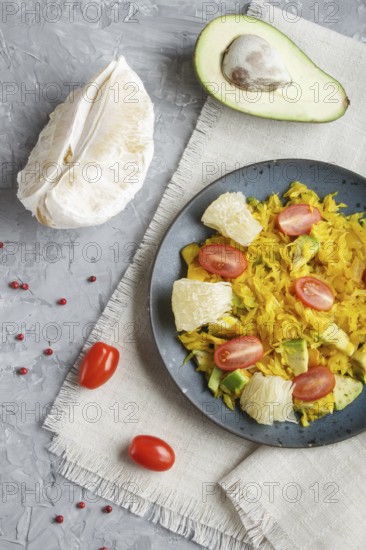 Fried pomelo with tomatoes and avocado on gray concrete background. Top view, myanmar food