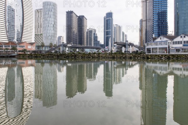 Batumi's modern skyscrapers reflect in the serene waters, highlighting the blend of contemporary architecture and natural beauty in Georgia's vibrant coastal city