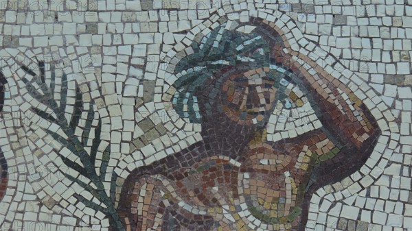 Mosaic with a figure holding a hand on its head and showing a palm tree, Museum of the History of the Ancient Olympic Games, Olympia, Peloponnese, Greece
