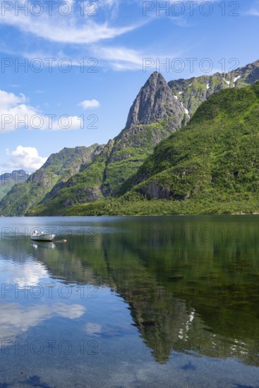 Small boats at the fjord Austnesfjorden, idyllic Norwegian fjord landscape, mountains reflected in the water, Sildpollen, Nordland, Norway