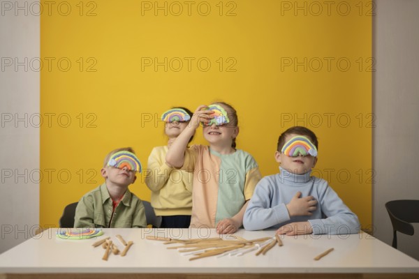 Children engage in a vibrant lesson, creatively using rainbow props to stimulate imagination and fun. The colorful setting encourages playful learning and collaboration