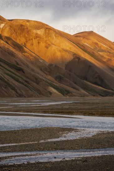 Rhyolite mountains and river Jökulgilskvísl, Landscape at Landmannalaugar, Dramatic volcanic landscape at sunset, Colourful erosion landscape with mountains, Landmannalaugar, Fjallabak Nature Reserve, Suðurland, Iceland