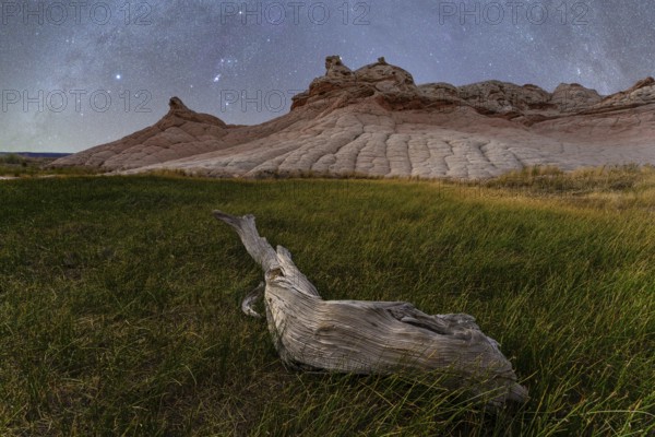 A serene spring night at Coyote Buttes in the Paria Canyon-Vermilion Cliffs Wilderness, Arizona, featuring a starry sky above the unique landscape