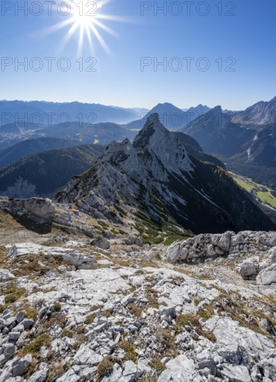 View at the summit of the Große Arnspitze, mountain panorama with Karwendel Mountains and Arnplattenspitze, sun star, autumnal mountain landscape, near Scharnitz, Bavaria, Germany