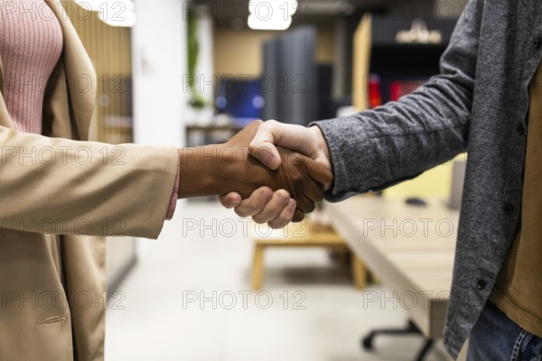 Two people are shaking hands in a modern office. The image captures the essence of professionalism, collaboration, and successful business interaction