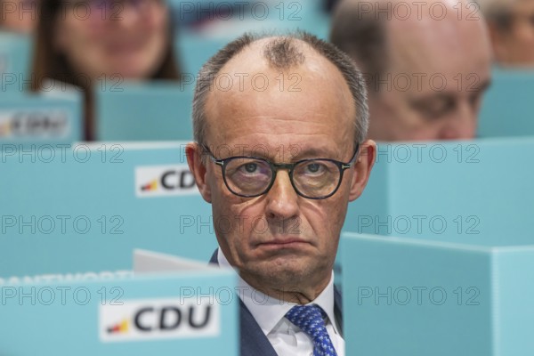 38th Federal Party Congress of the CDU of Germany in Stuttgart. Federal Chancellor Friedrich Merz has left the stage and podium and is sitting in the ranks of delegates from the state association of North Rhine-Westphalia during the election. Privacy when voting by secret ballot. Stuttgart, Baden-Württemberg, Germany