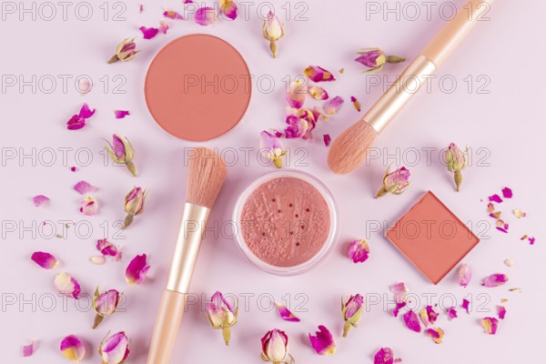 Aesthetic flat lay of pink makeup brushes and cosmetics surrounded by delicate rose petals on a light background Perfect for beauty and fashion-related projects