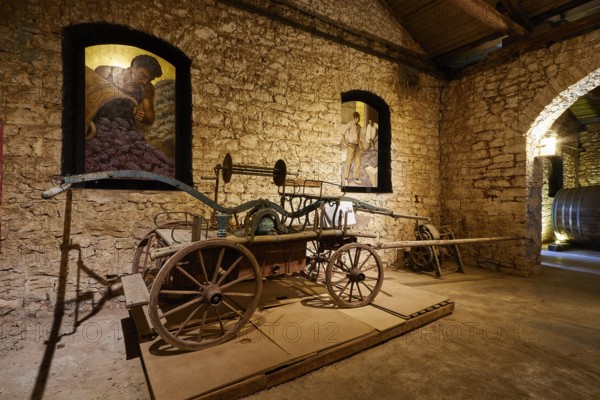 Historic car in a wine cellar surrounded by stone walls, Achaia Clauss Winery, Patras, Peloponnese, Greece