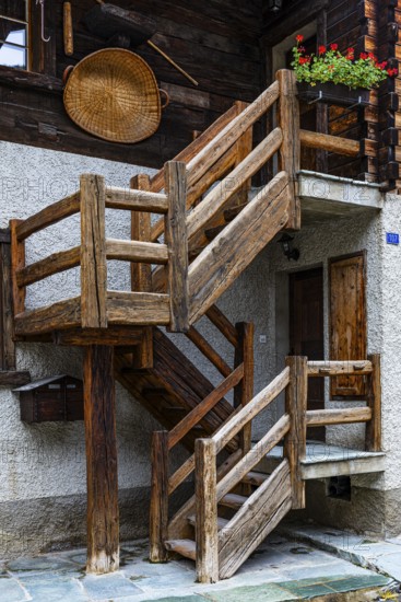 Wooden staircase on the outside of an old house in the historic village centre, Grimentz, Val d'Anniviers, Valais Alps, Canton Valais, Switzerland
