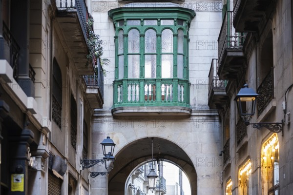 Narrow alley and bridge in the Gothic Quarter in the historic centre of Barcelona, Spain