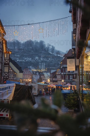 View of an illuminated Christmas market with half-timbered houses in a wintry atmosphere, Christmas market Calw, Black Forest, Germany
