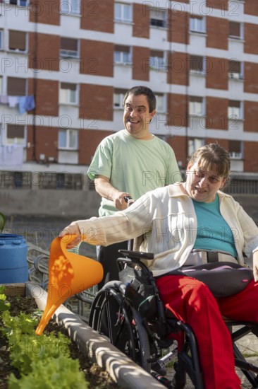 Two individuals at a day center participate in gardening, nurturing plants in an outdoor garden. The scene highlights inclusion, support, and the joy of shared activities
