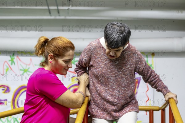 A compassionate caregiver assists a resident in a mental health facility, showcasing empathy and support. The setting emphasizes care and community involvement