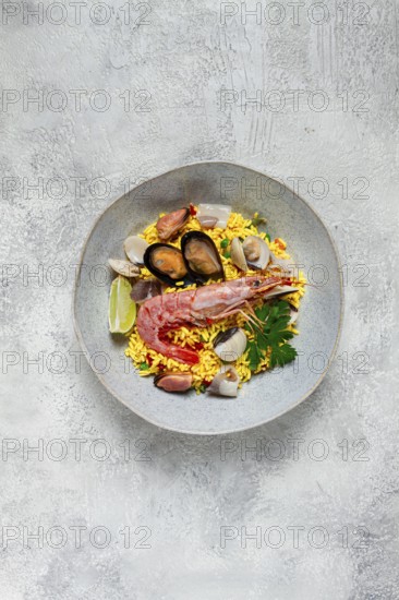 Seafood paella, on a plate, traditional Spanish dish, top view, no people