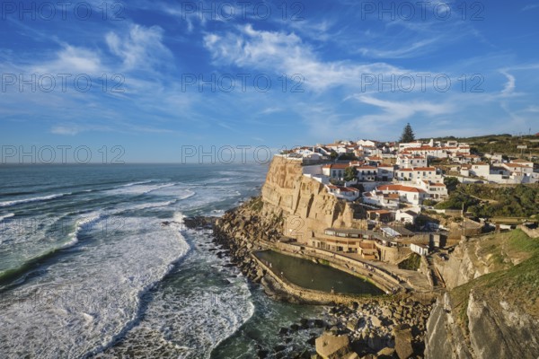 Explore the stunning seaside village of Azenhas do Mar nestled on high cliffs along the Atlantic Ocean. The vibrant white buildings contrast beautifully with the deep blue sea and sky