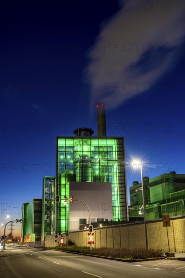 The Lausward combined heat and power plant in Düsseldorf, gas and steam turbine power plant, operated by Stadtwerke Düsseldorf and EnBW, in the harbour of Düsseldorf on the Rhine, green illuminated city window, the chimney of the Fortuna power plant unit, the power plant generates electricity, also traction current and district heating, North Rhine-Westphalia, Germany