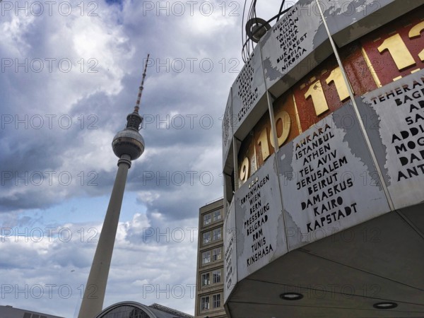 Cloudy sky over the Berlin World Clock and the Berlin TV Tower at Alexanderplatz, Alex, Mitte, Berlin