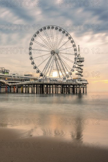 Ferris wheel at sunset on the pier at the beach, The Hague, Netherlands
