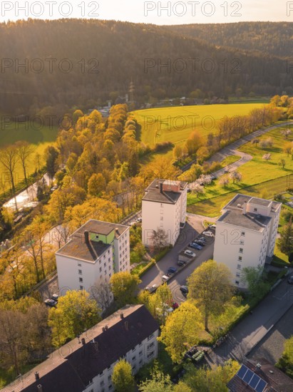 Residential buildings in an urban landscape next to forests and fields in the sunlight, Nagold, district of Calw, Germany