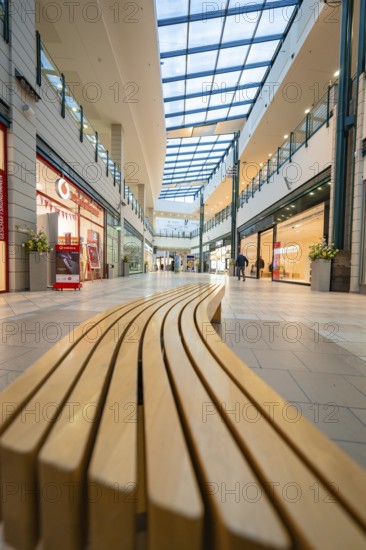 Interior view of a modern shopping centre with long bench and glass roof, Sterncenter Sindelfingen, Böblingen district, Germany