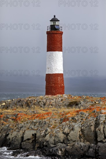 Lighthouse on rocky terrain under a cloudy sky, The lighthouse in the Beagle Channel near Ushuaia in Argentina