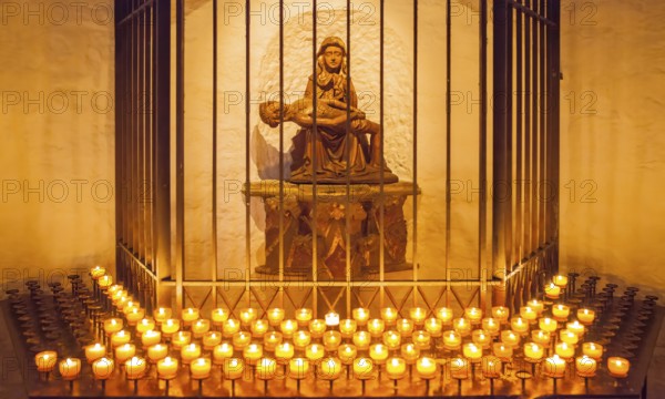 Pietà and votive candle rack at Minden Cathedral, Minden, North Rhine-Westphalia, Germany