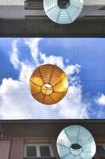 Decorative lanterns in front of bright blue sky