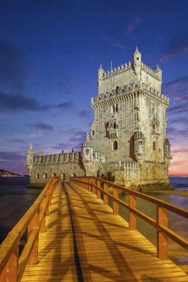 Belem Tower or Tower of St Vincent, famous tourist landmark of Lisboa and tourism attraction, on the bank of the Tagus River (Tejo) after sunset in dusk twilight with dramatic sky. Lisbon, Portugal