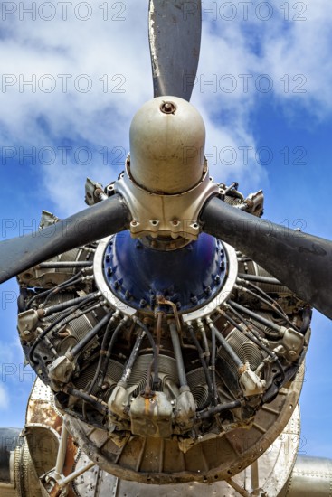 Close-up of an aircraft propeller against a blue sky, technical details visible, The propeller of an aeroplane at Ushuaia airport in Argentina
