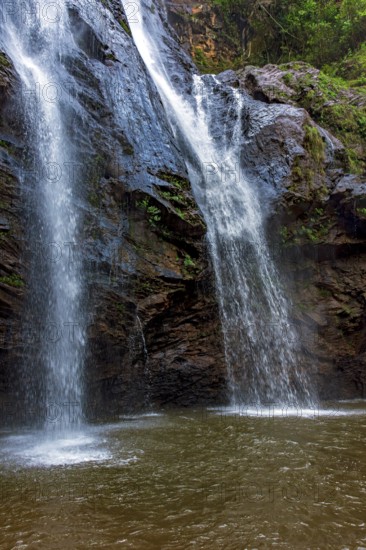 Water from the waterfall running over the rocks inside the rainforest in Minas Gerais, Brazil, Minas Gerais, Brazil