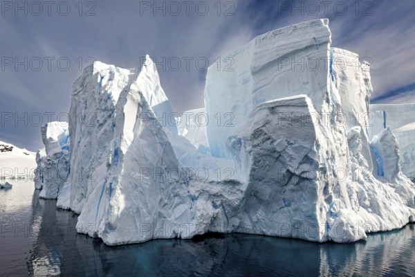 Majestic, towering icebergs with sharp edges against a dark sky, icebergs in the landscape of the Southern Ocean in Antarctica