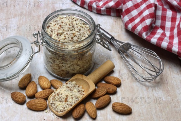 Almonds and ground almonds in glass, Prunus amygdalus