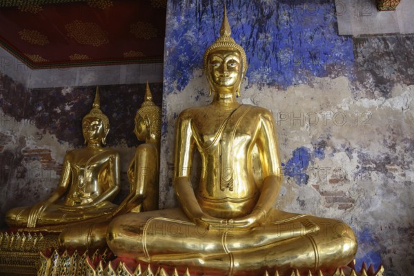 Bangkok, Thailand. February 20th 2025. A beautiful display of seated golden Buddha statues at the The Wat Suthat Thepwararam Temple