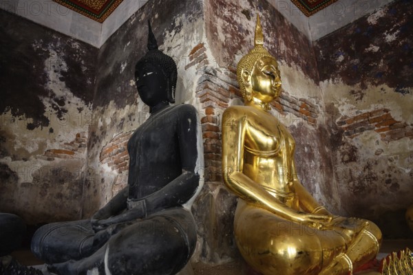 Bangkok, Thailand. February 20th 2025. A black and a gold Buddha statue on display in the The Wat Suthat Thepwararam Temple